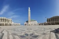 Panoramic view of the Casablanca cityscape featuring the iconic Hassan II Mosque on the Atlantic coast, the primary destination for private transfers from Marrakech Airport.