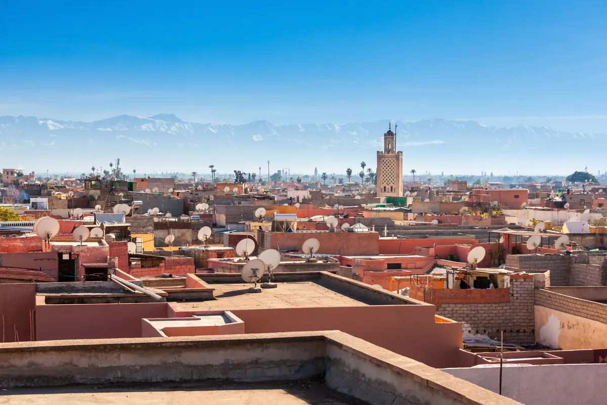 Panoramic view of the historic Marrakech Medina featuring the Koutoubia Mosque, the primary destination for private Riad transfers from Marrakech Menara Airport.
